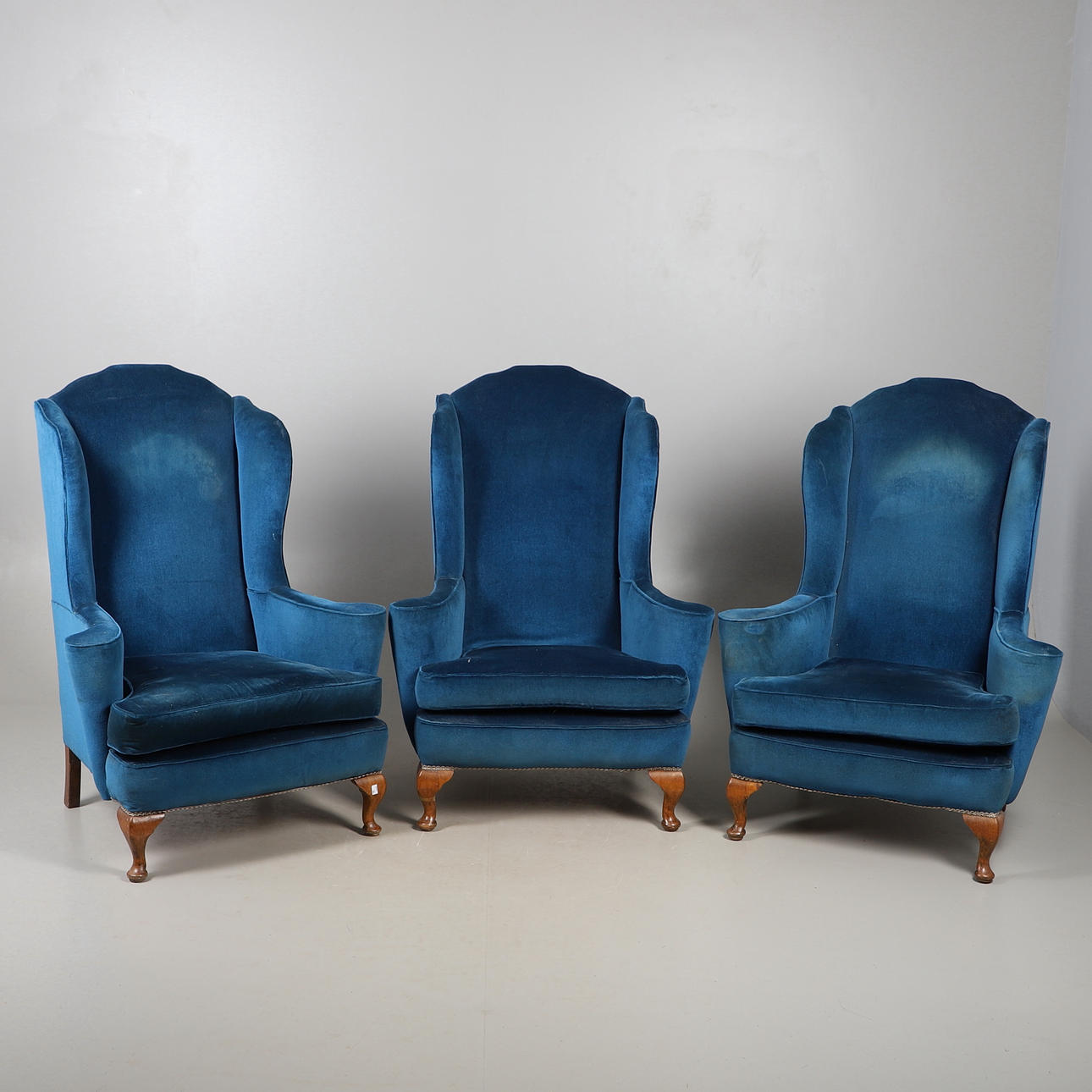 THREE WING BACK ARMCHAIRS.