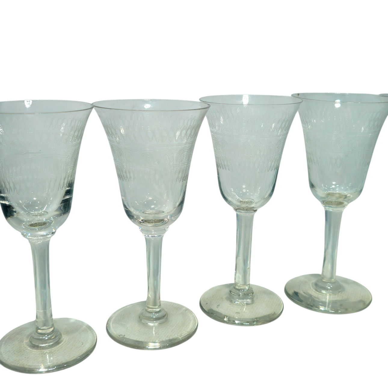 Six crystal liquor glasses with engraved border.