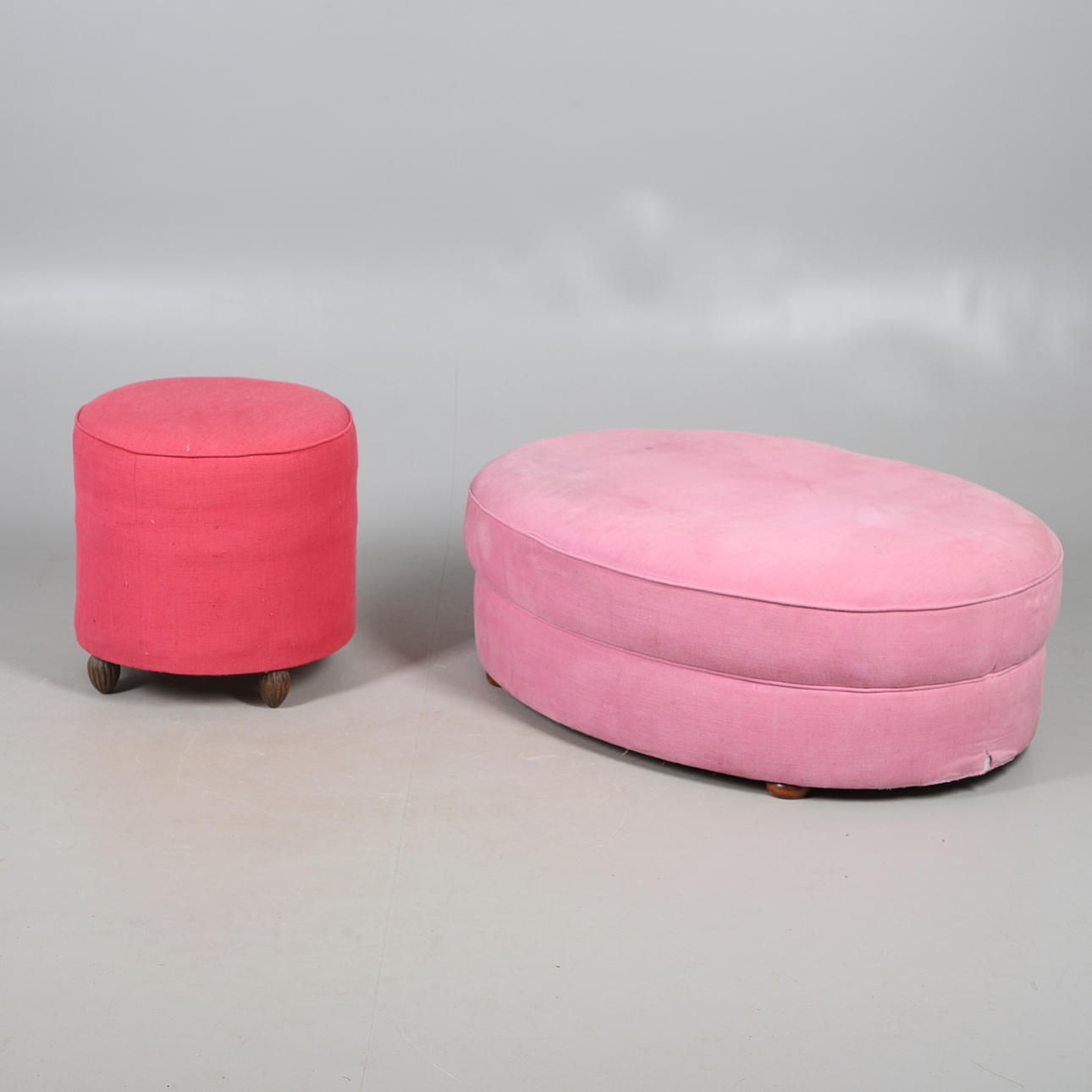 TWO UPHOLSTERED POUFFES.