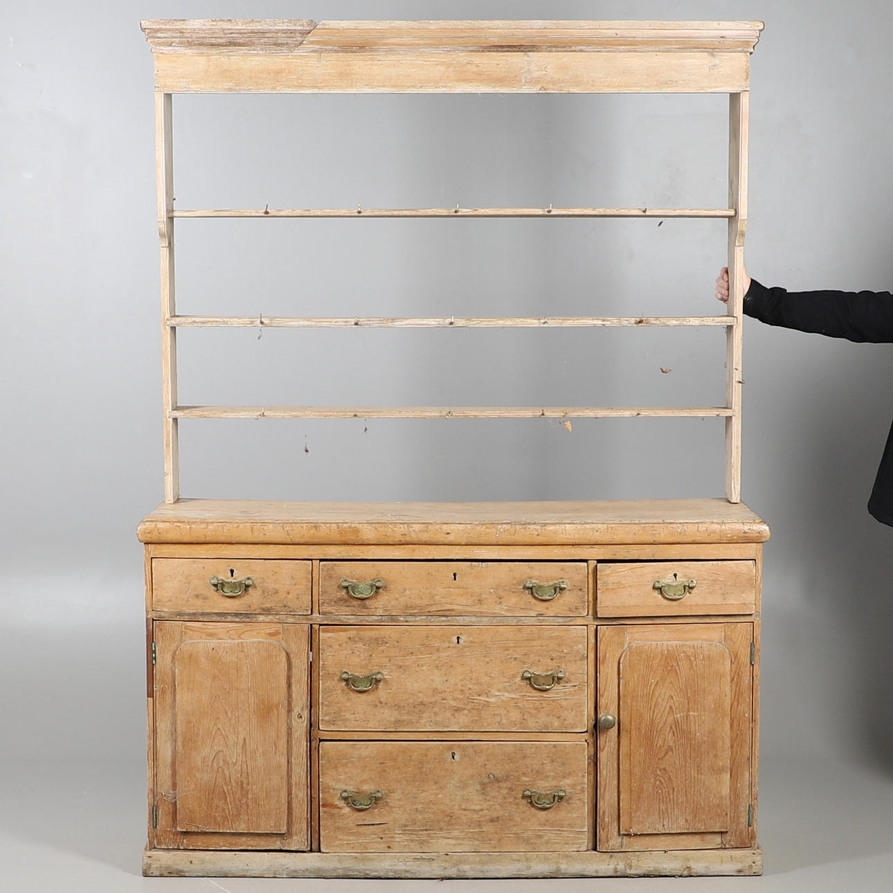 A STRIPPED AND WAXED PINE OPEN BACK DRESSER.