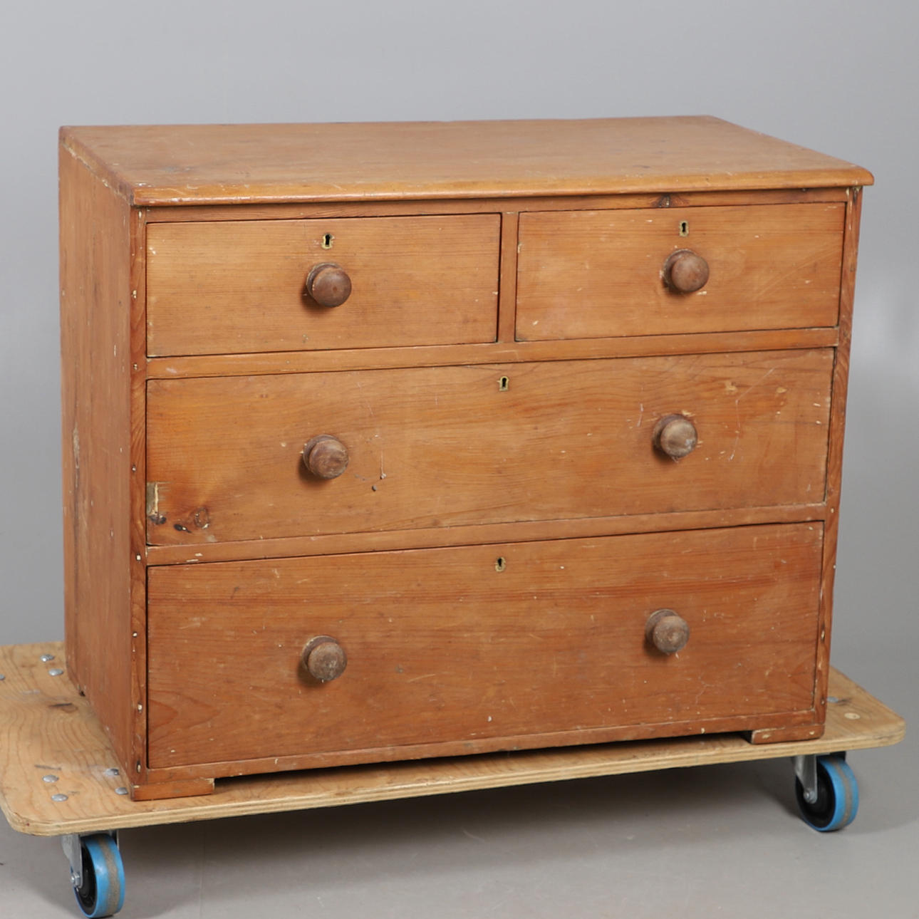 A STRIPPED PINE FOUR DRAWER CHEST.