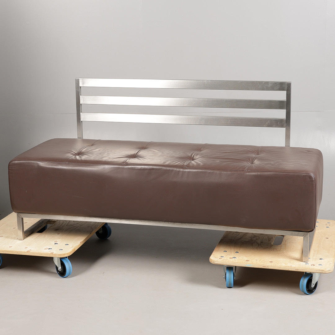 A MODERN METAL FRAMED BENCH.