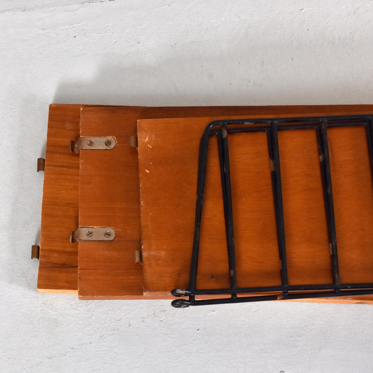 NILS STRINNING. wall shelf, teak and lacquered metal, “String”.