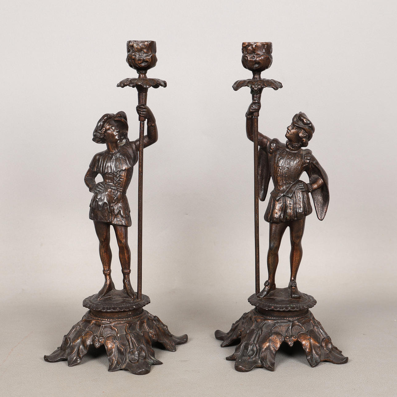 A PAIR OF CONTINENTAL BRONZED FIGURAL CANDLESTICKS (2).