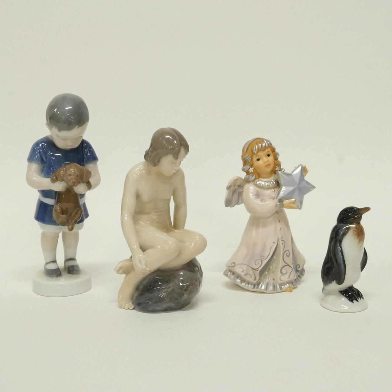 FOUR FIGURINES.