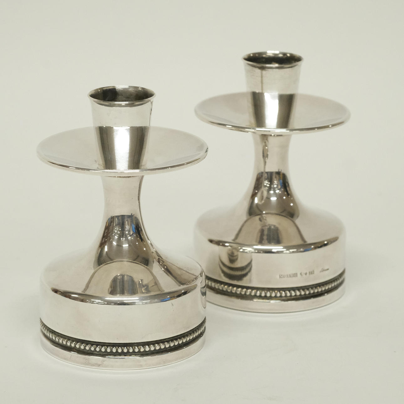 ERIC LÖFMAN. A PAIR OF CANDLESTICKS, SILVER.