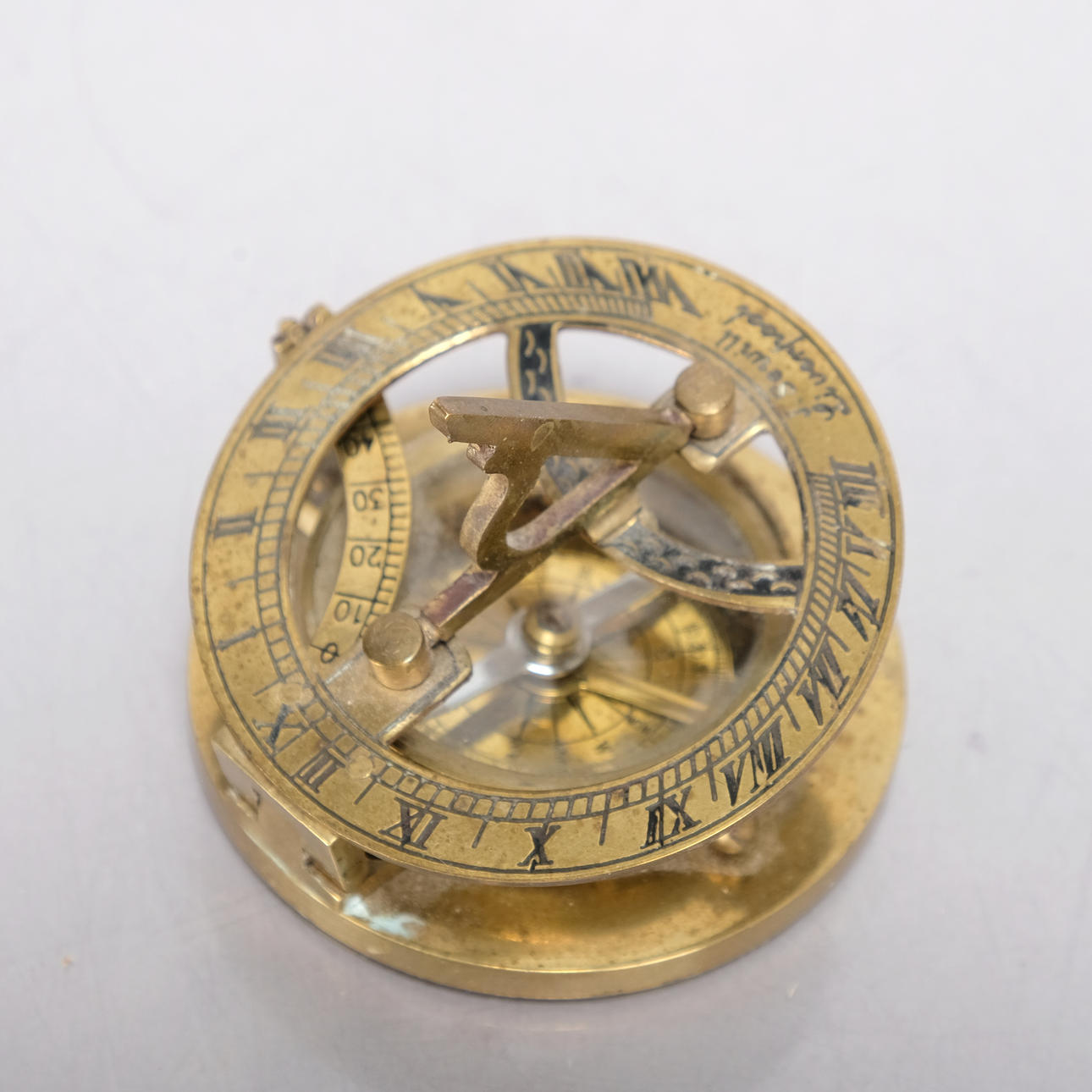 A brass solar/compass, marked J. Sewill Liverpool.