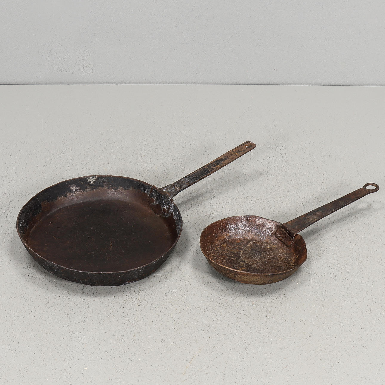Two iron frying pans, 19th century.