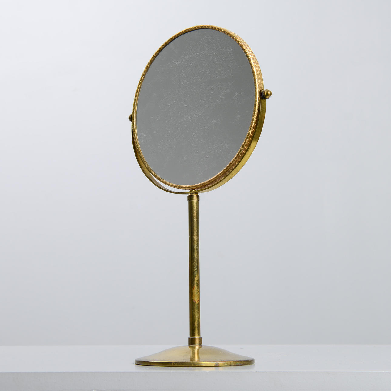 TABLE MIRROR, brass, mid-20th century.