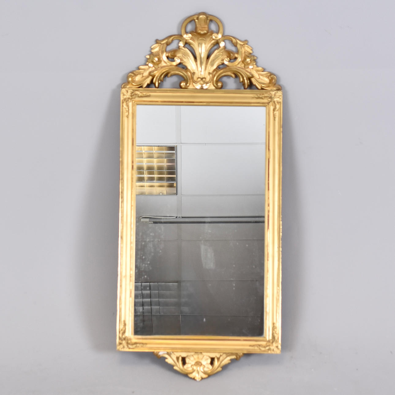 A mirror, gilt, Rococo style, 20th century.