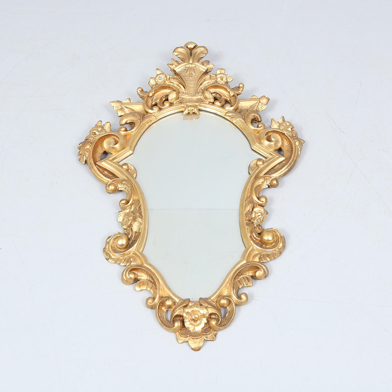 A 20th century rococo style mirror.