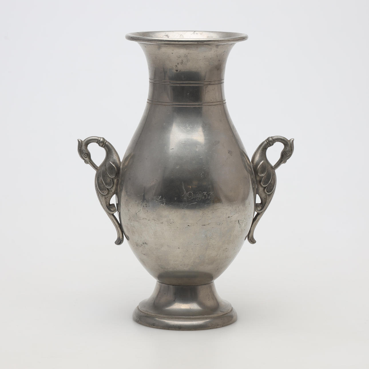 A pewter pendant vase.