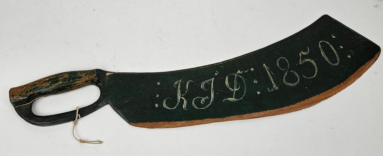 A WOODEN CUTTING KNIFE, dated 1850.