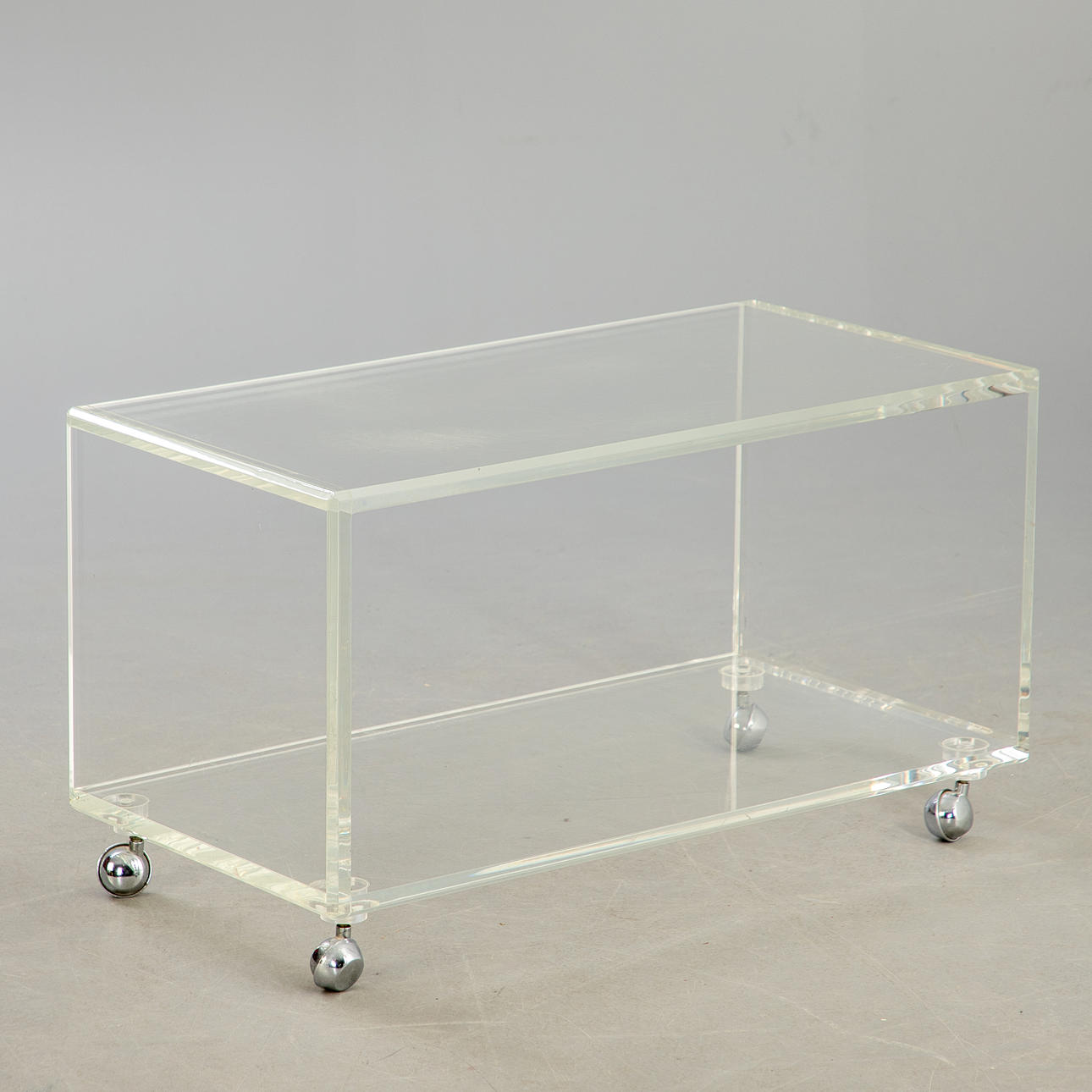 Acrylic trolley / side table on casters.