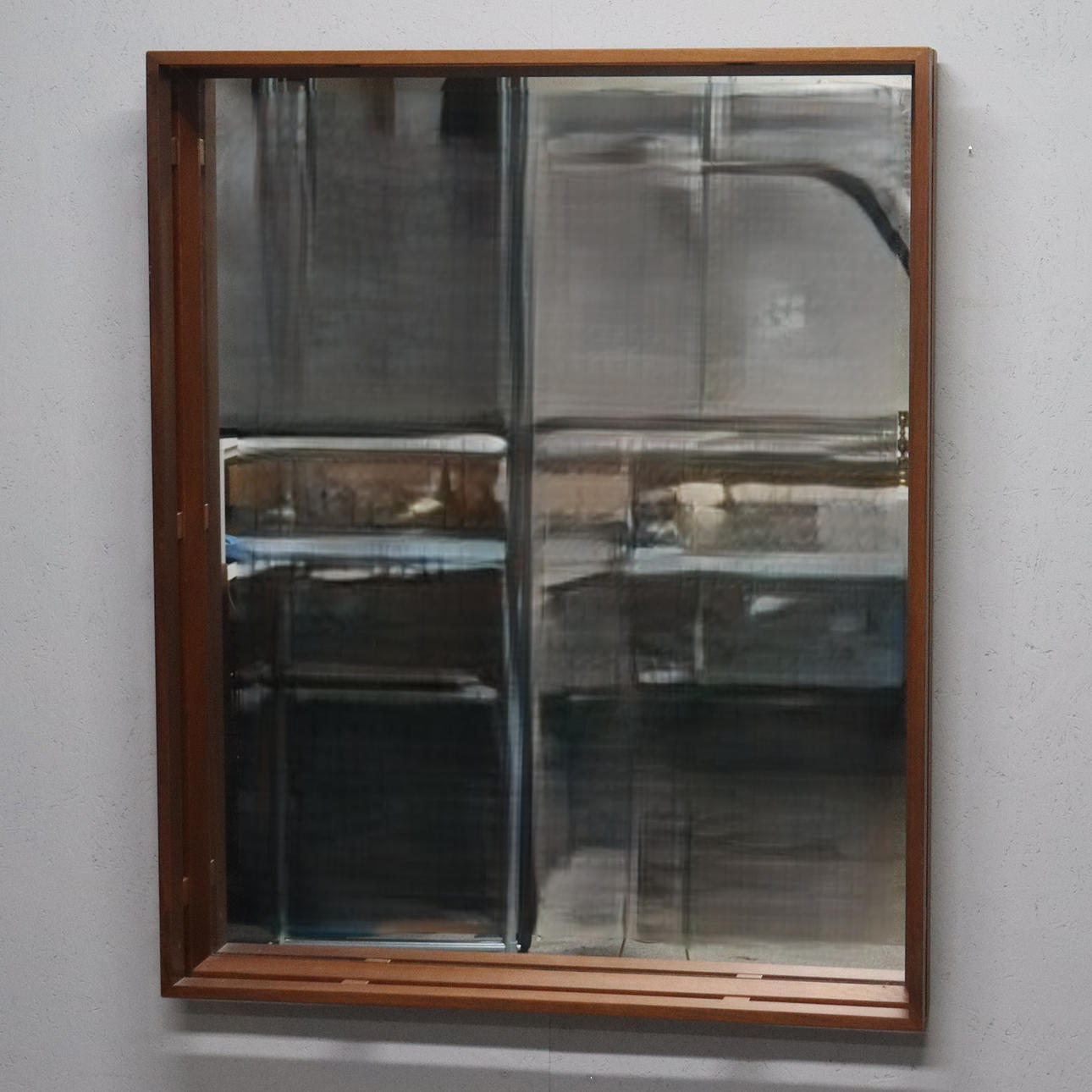 A 1960s teak mirror.