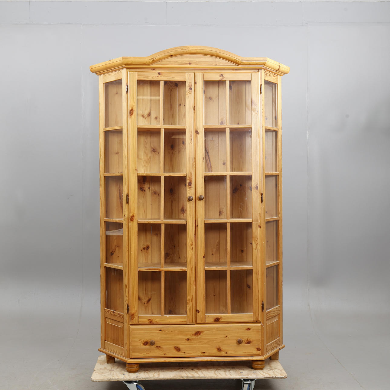 A contemporary pine display cabinet.
