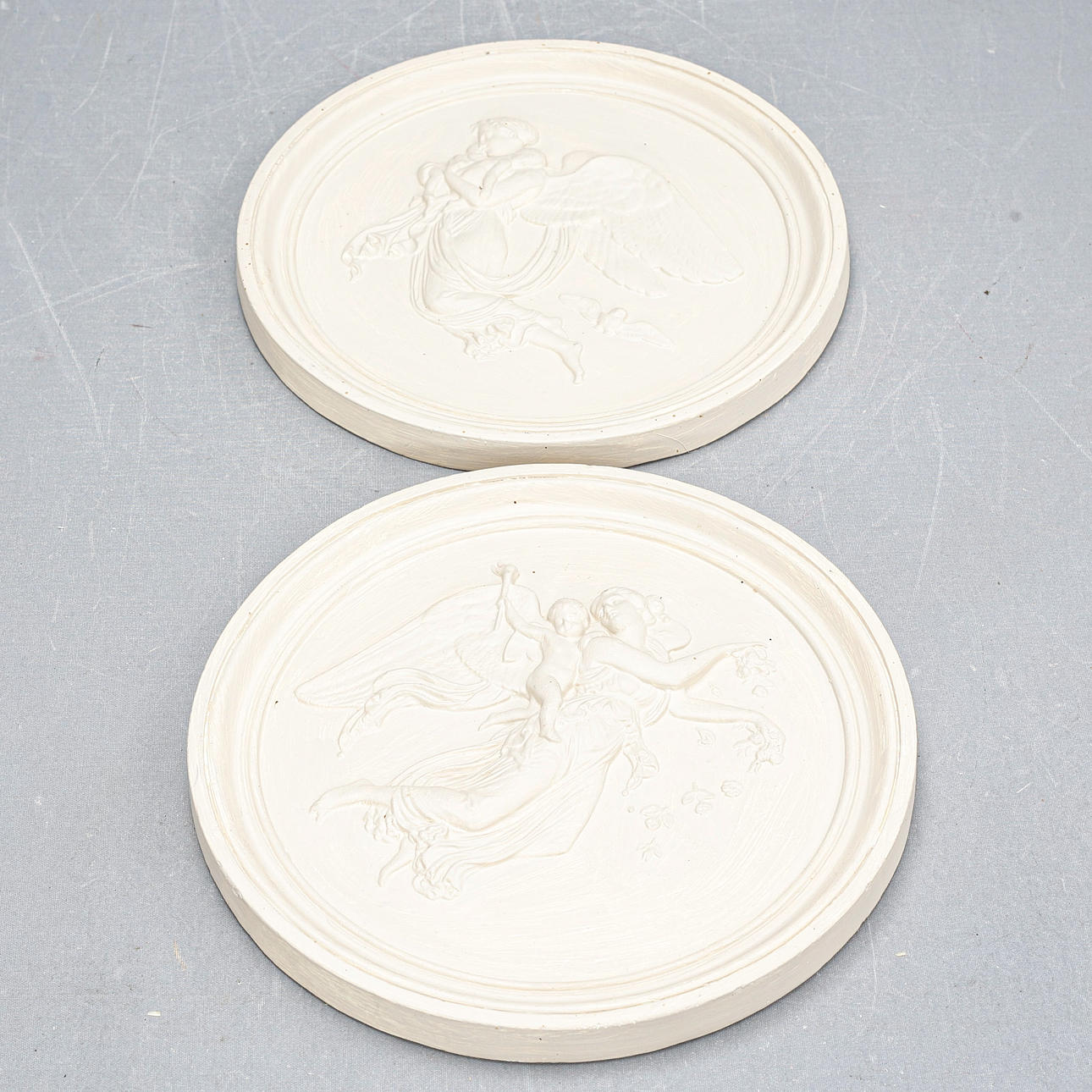 Two wall reliefs, painted, plaster, 20th century.