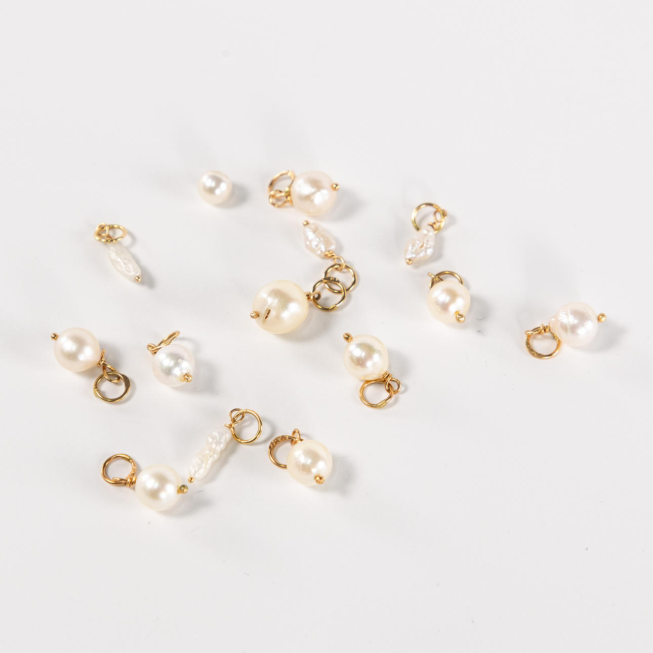 PEARLS, with loops in 18k gold.