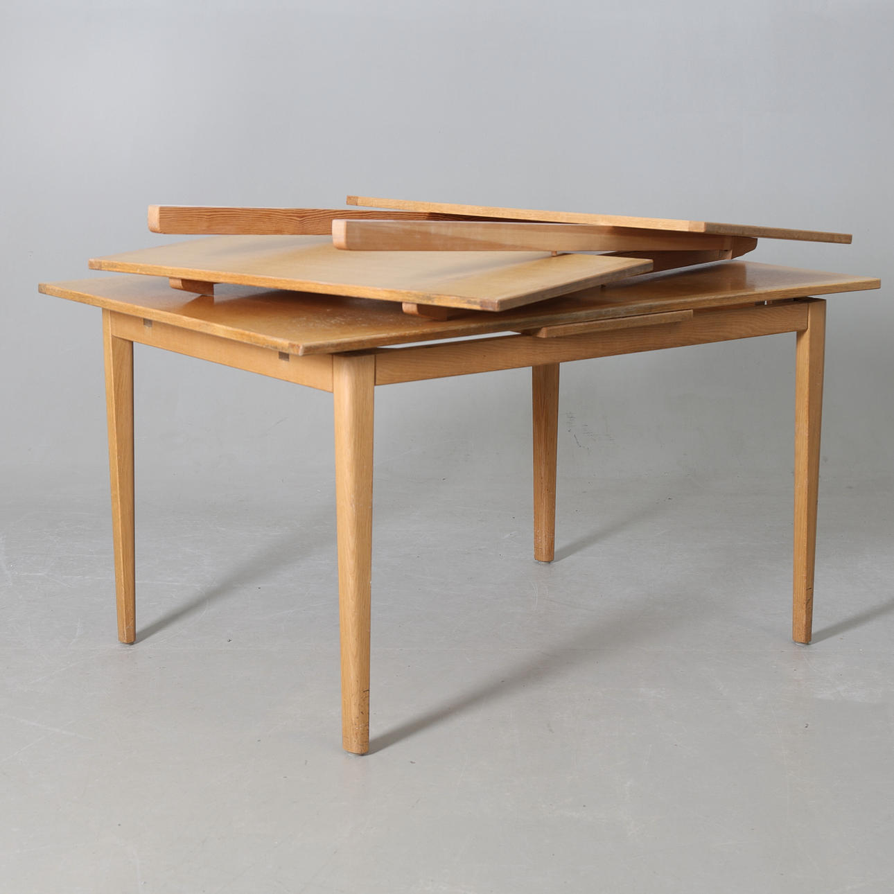 An oak table with inserts, 20th century.