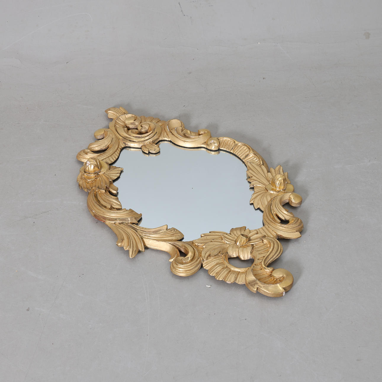 A gilded rococo mirror, 20th century.