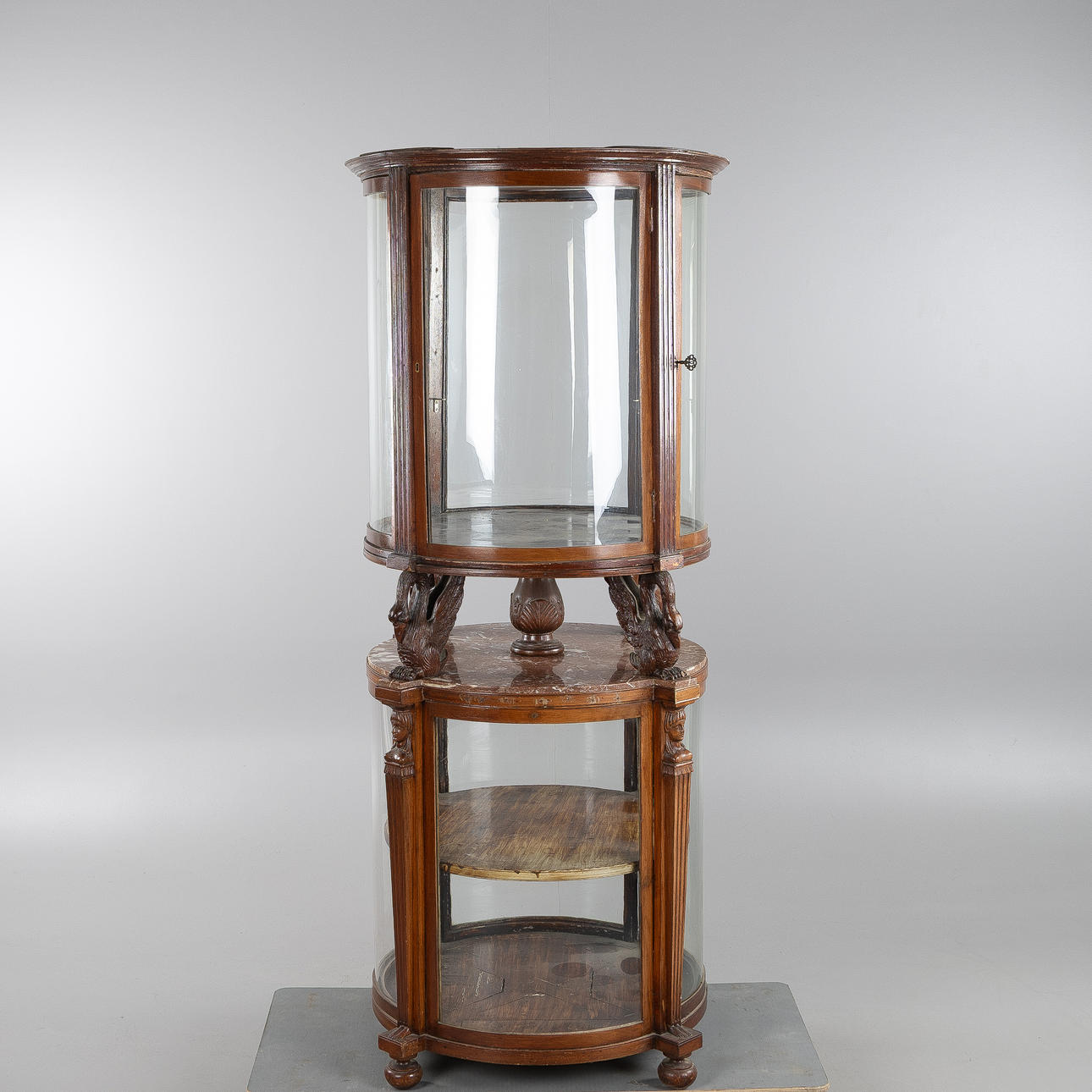 A round divisible display cabinet, early 20th century.