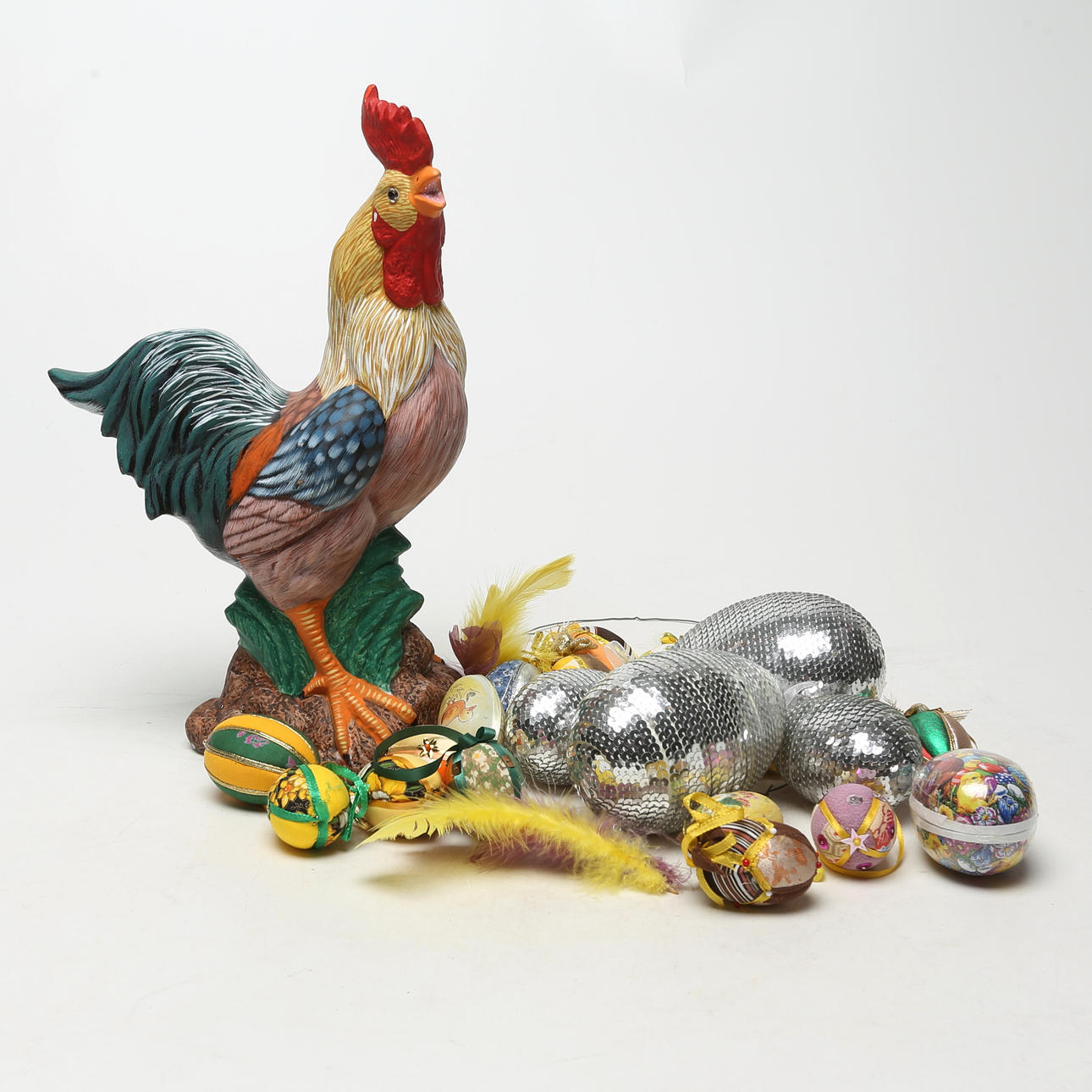 A ceramic rooster. with several eggs.