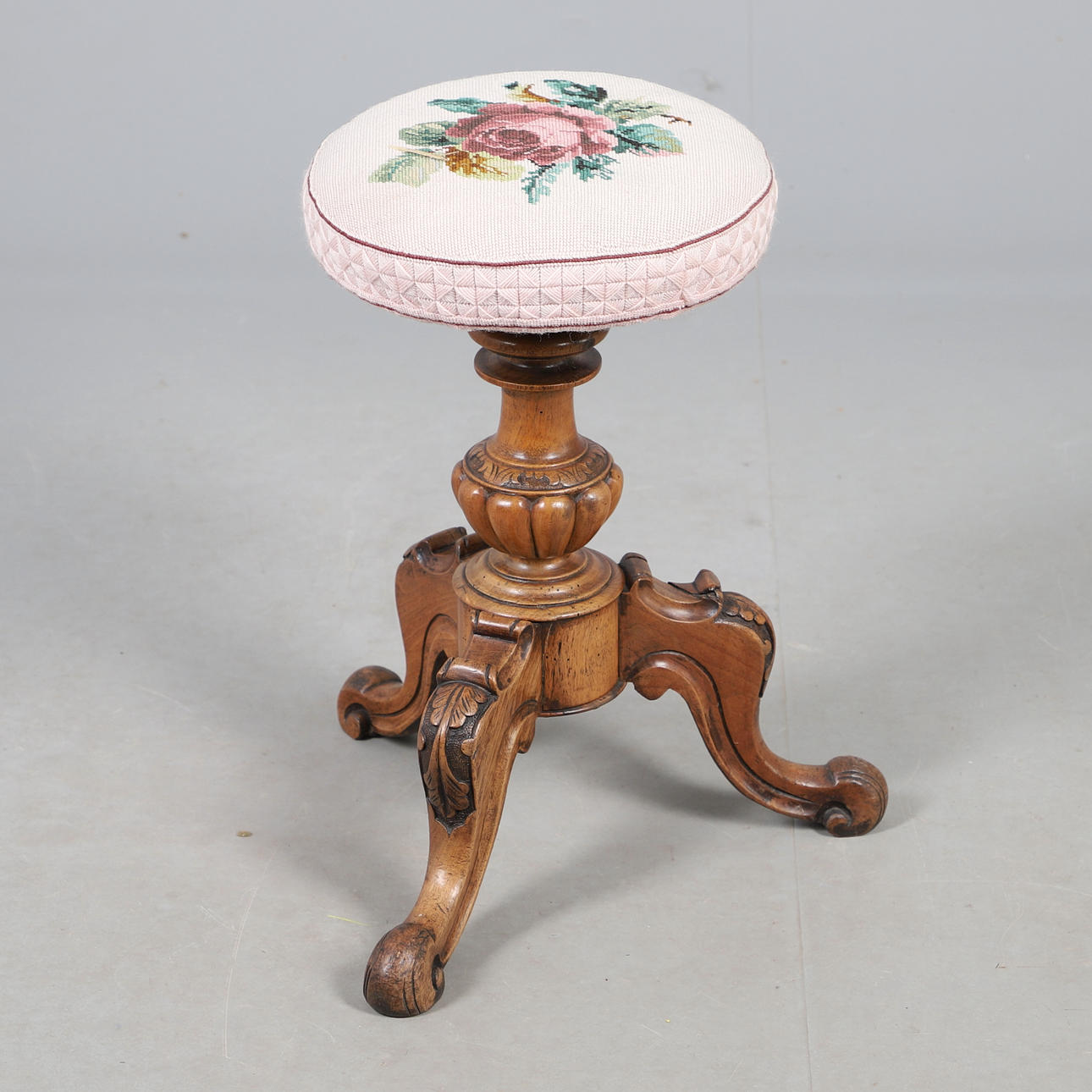 A VICTORIAN WALNUT PIANO STOOL.