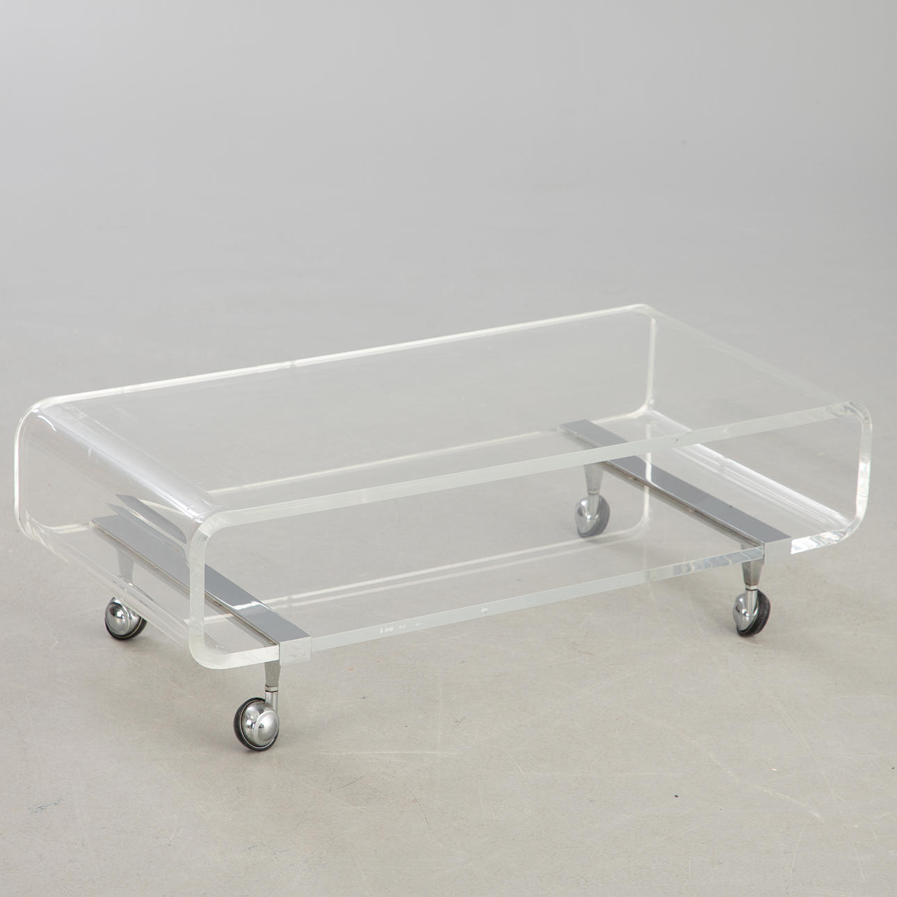 Low acrylic trolley/sofa table on wheels.