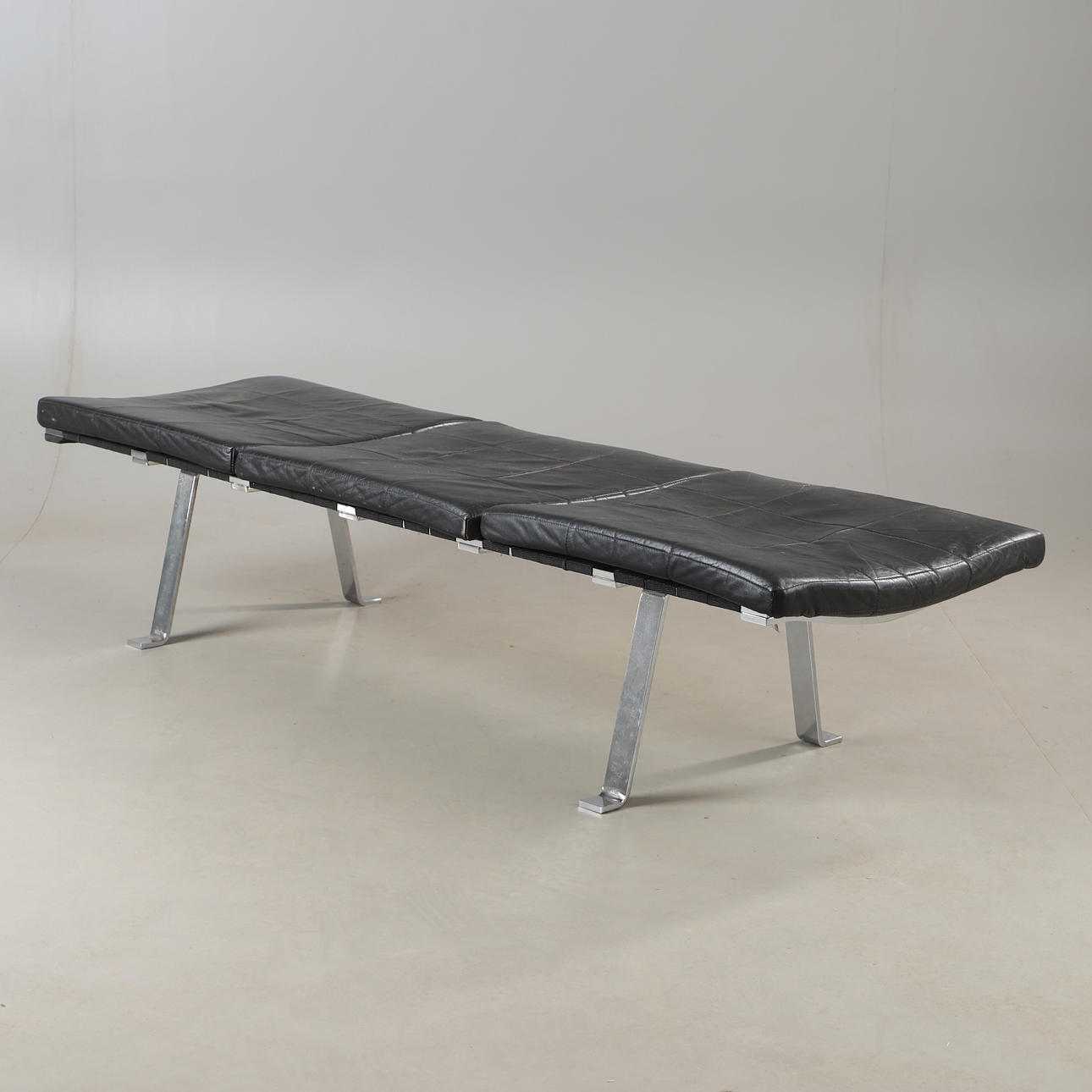 A leather and metal seating bench, 2000's.