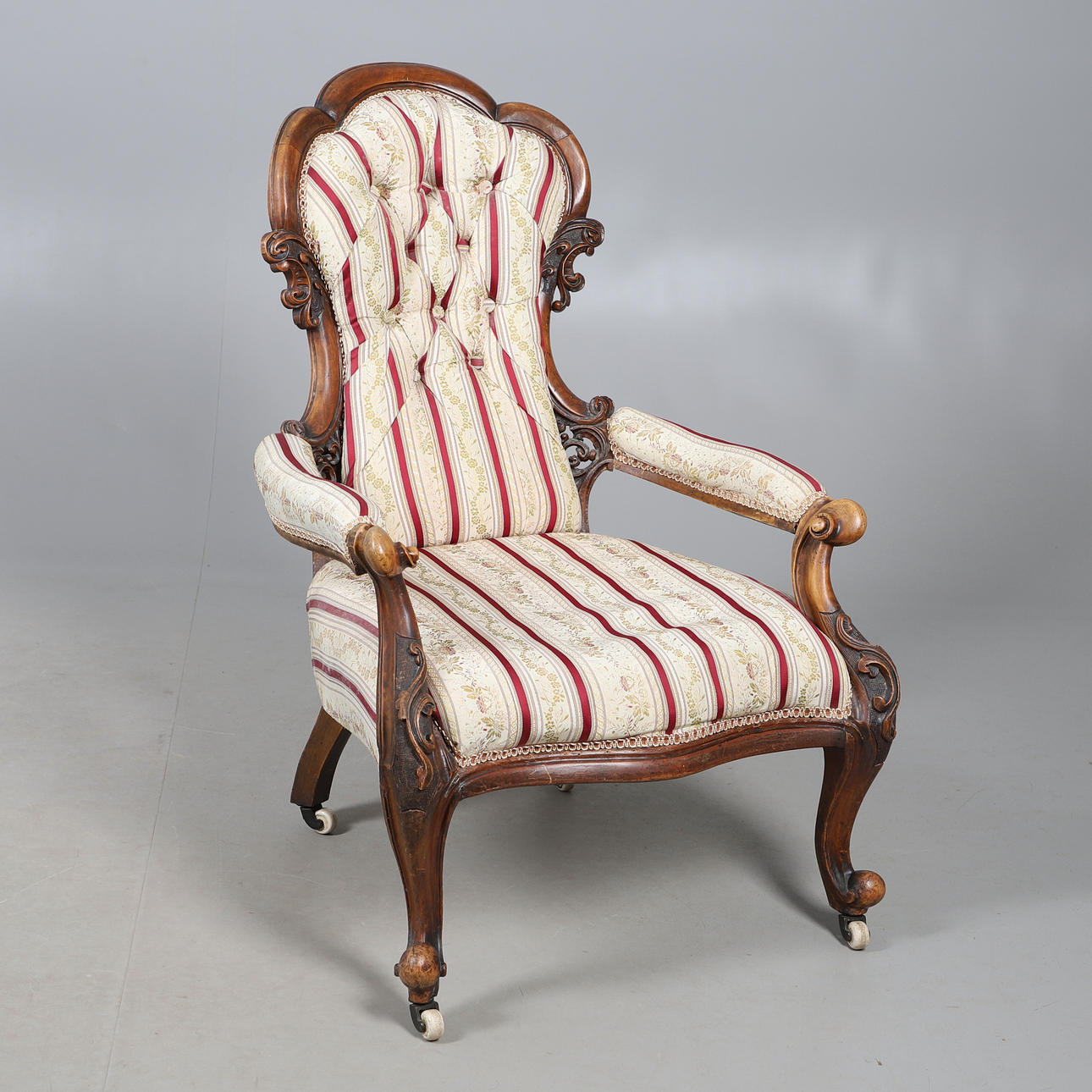 A VICTORIAN MAHOGANY SCROLL FRAME ARMCHAIR.