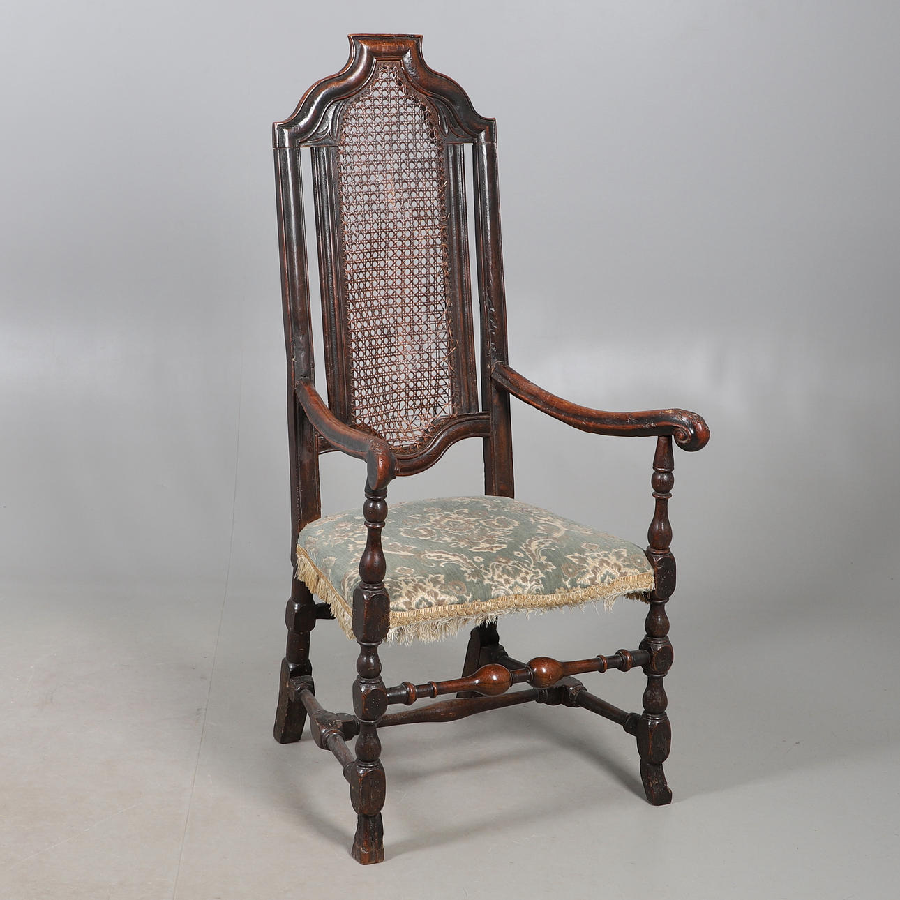 A CAROLEAN STYLE OAK OPEN ARMCHAIR.