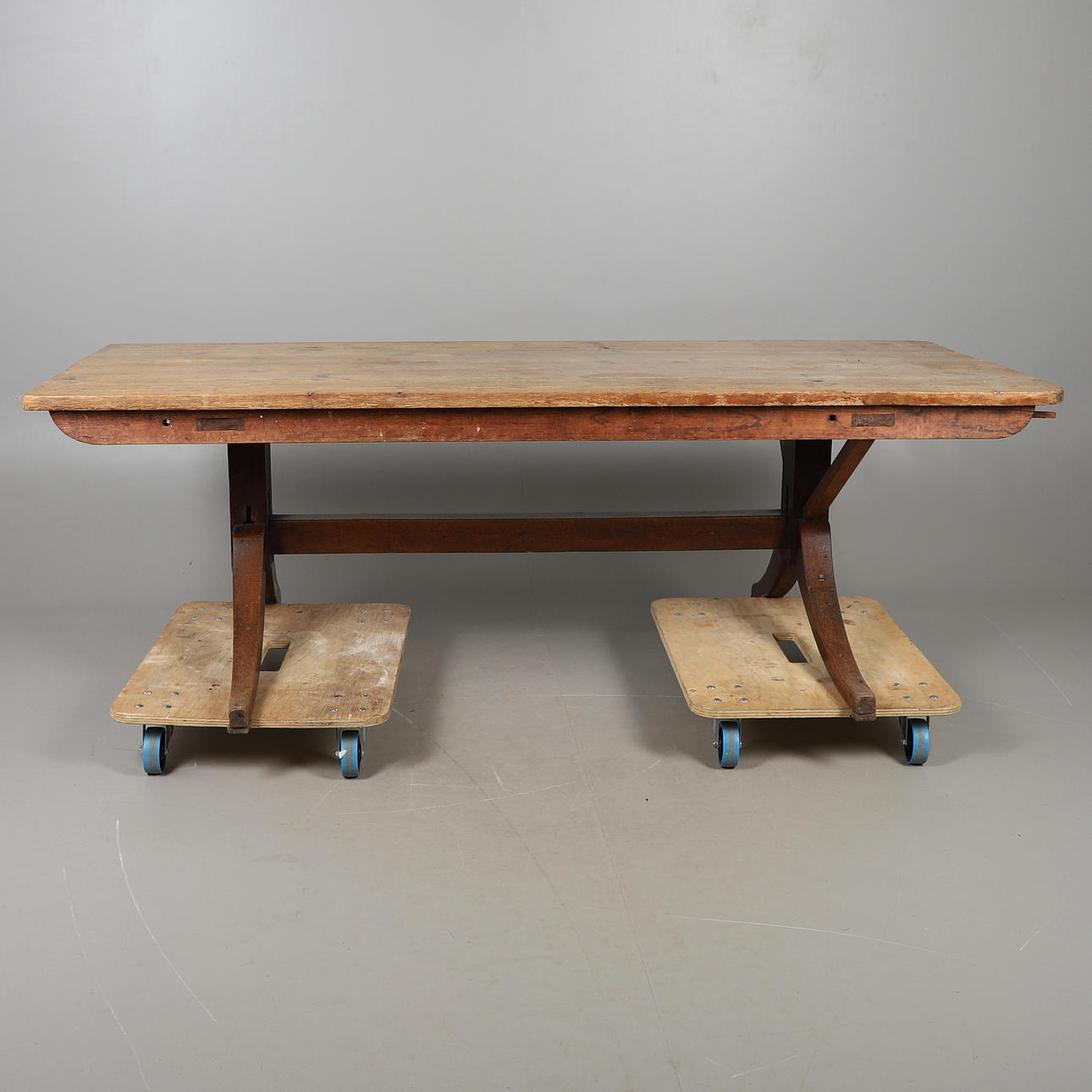 A RUSTIC PINE REFECTORY TABLE TOP ON OAK BASE.