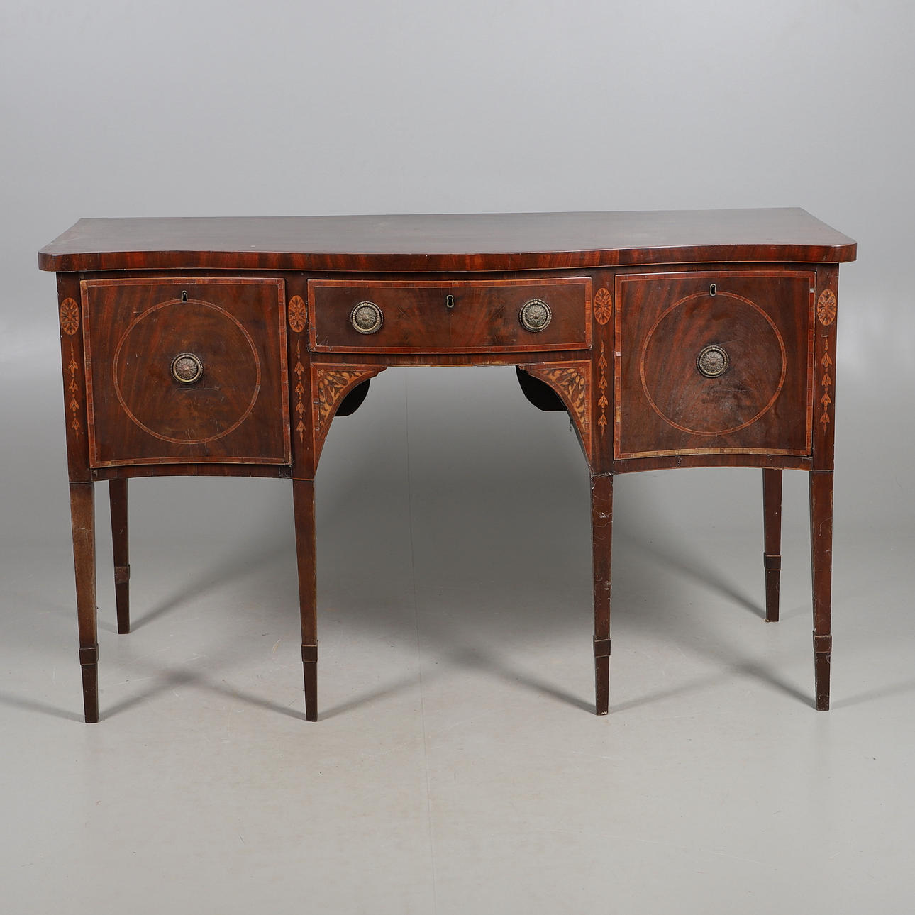 A SERPENTINE FRONTED INLAID MAHOGANY SIDEBOARD.