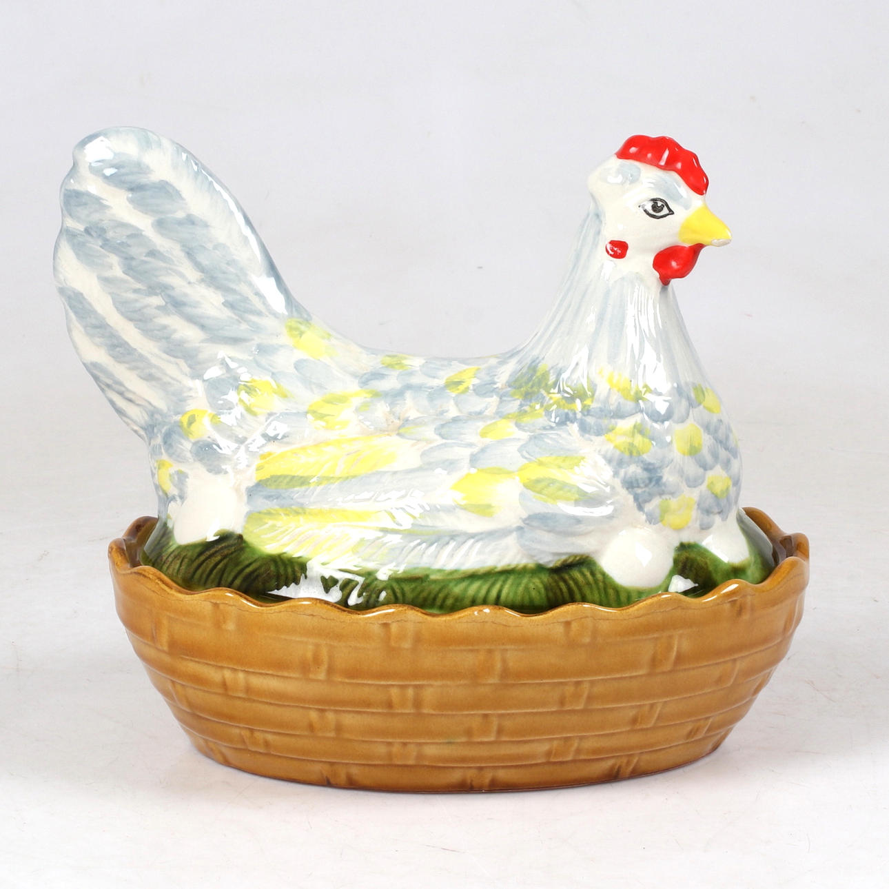 A 20th century porcelain egg hen.