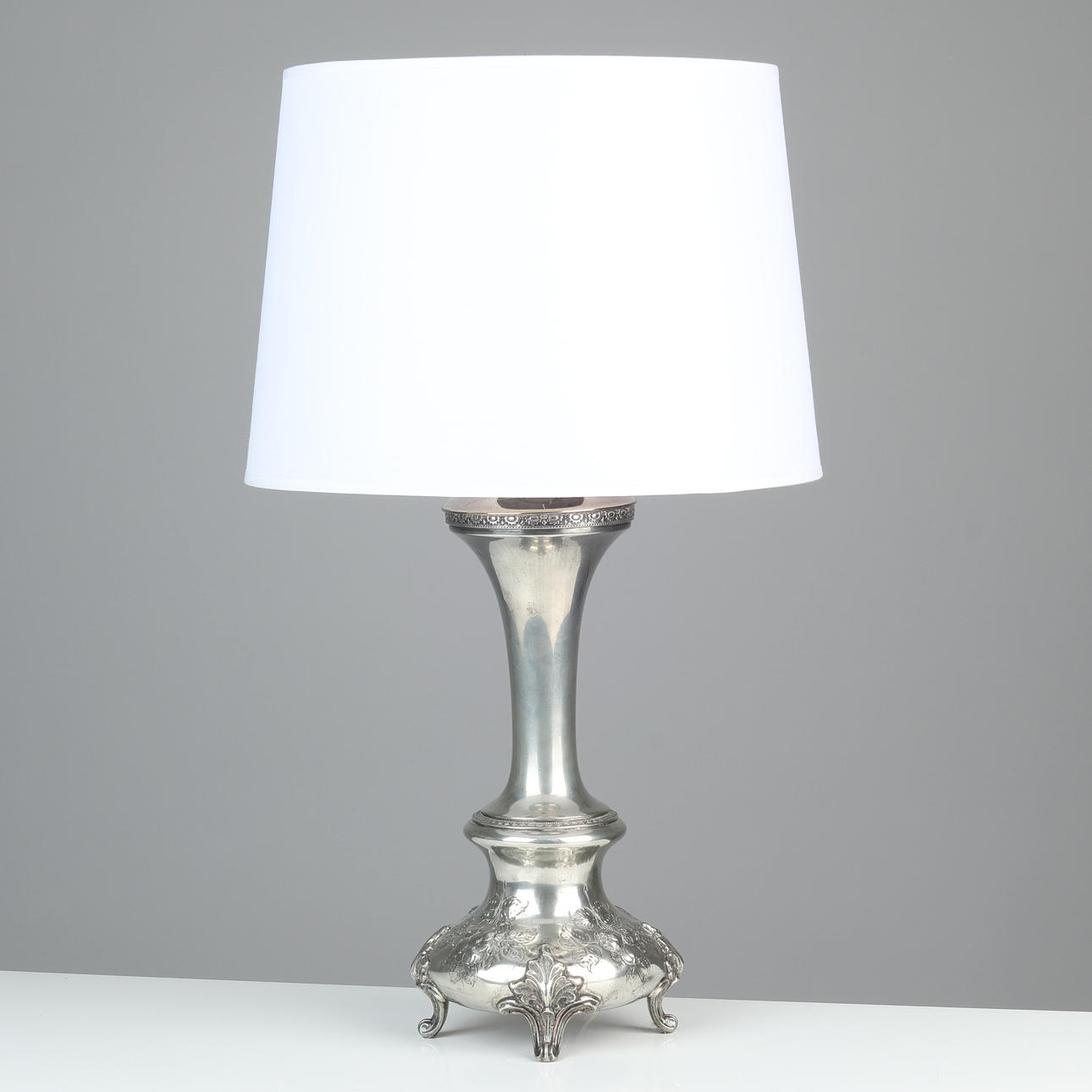 Table lamp made of speckled silver, rococo shape. 1900's first half.