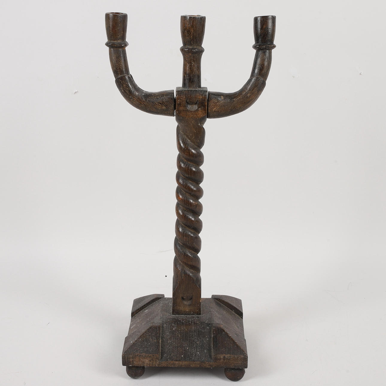 A wooden candlestick, three-armed, 19th century.