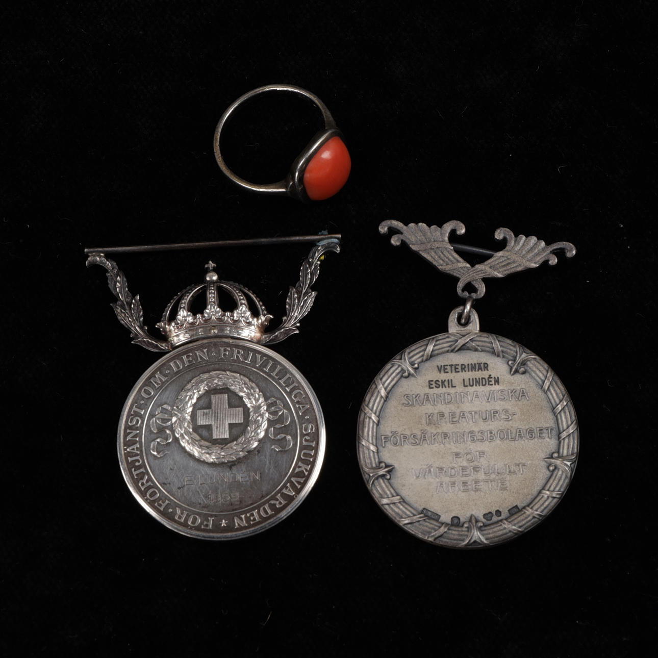MEDALS AND RING, silver, total weight 43 grams.