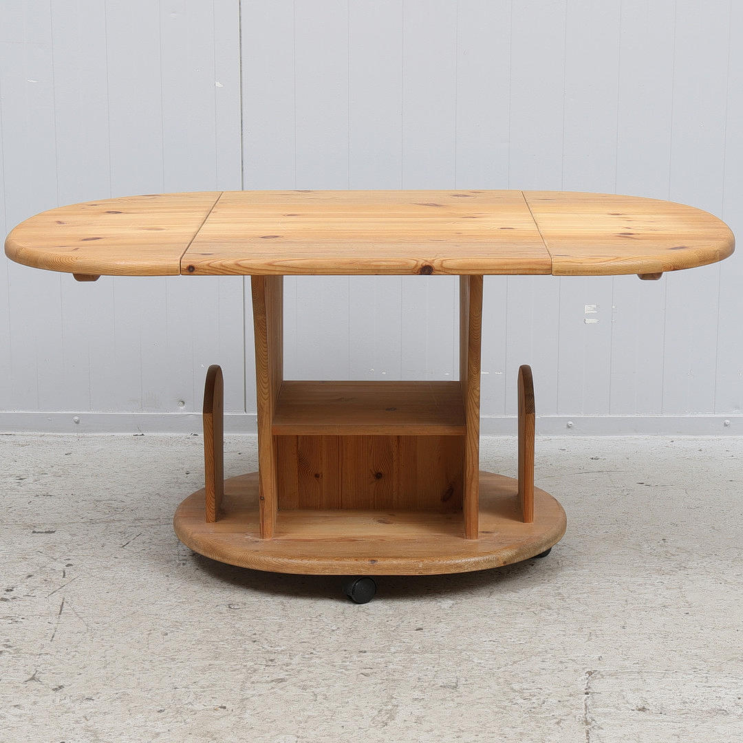 A 1900/2000 century pine coffee table on wheels.