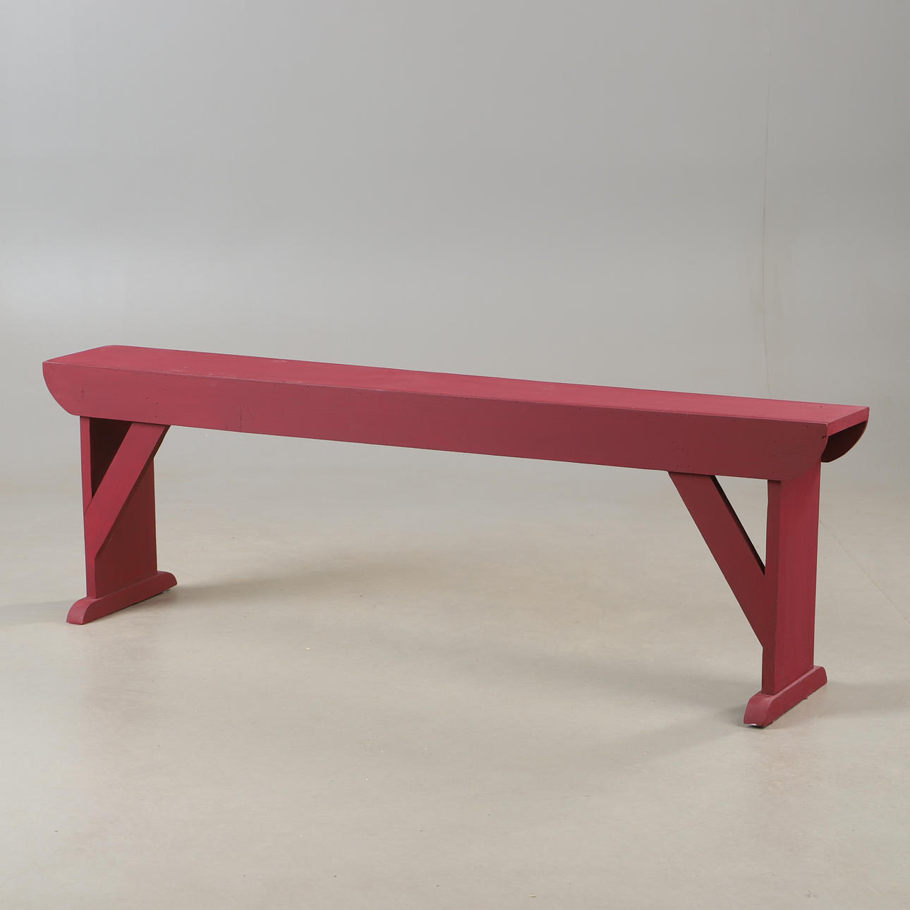 A bench, painted in red, 20th century.