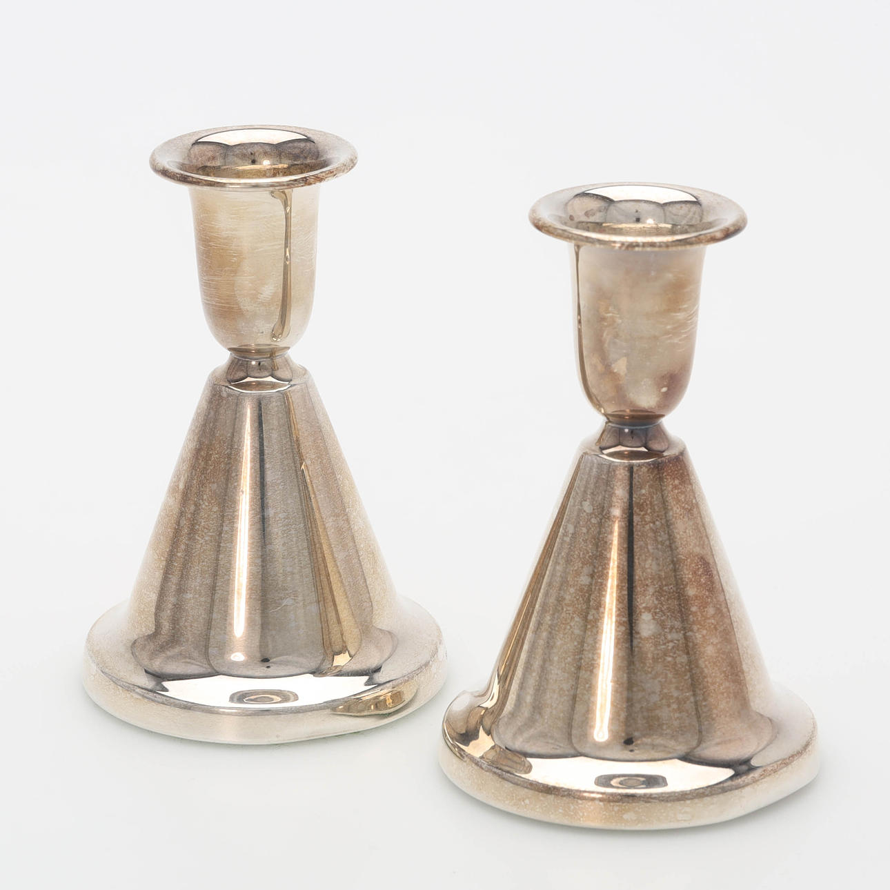 A pair of silver candlesticks, foreign stamps.