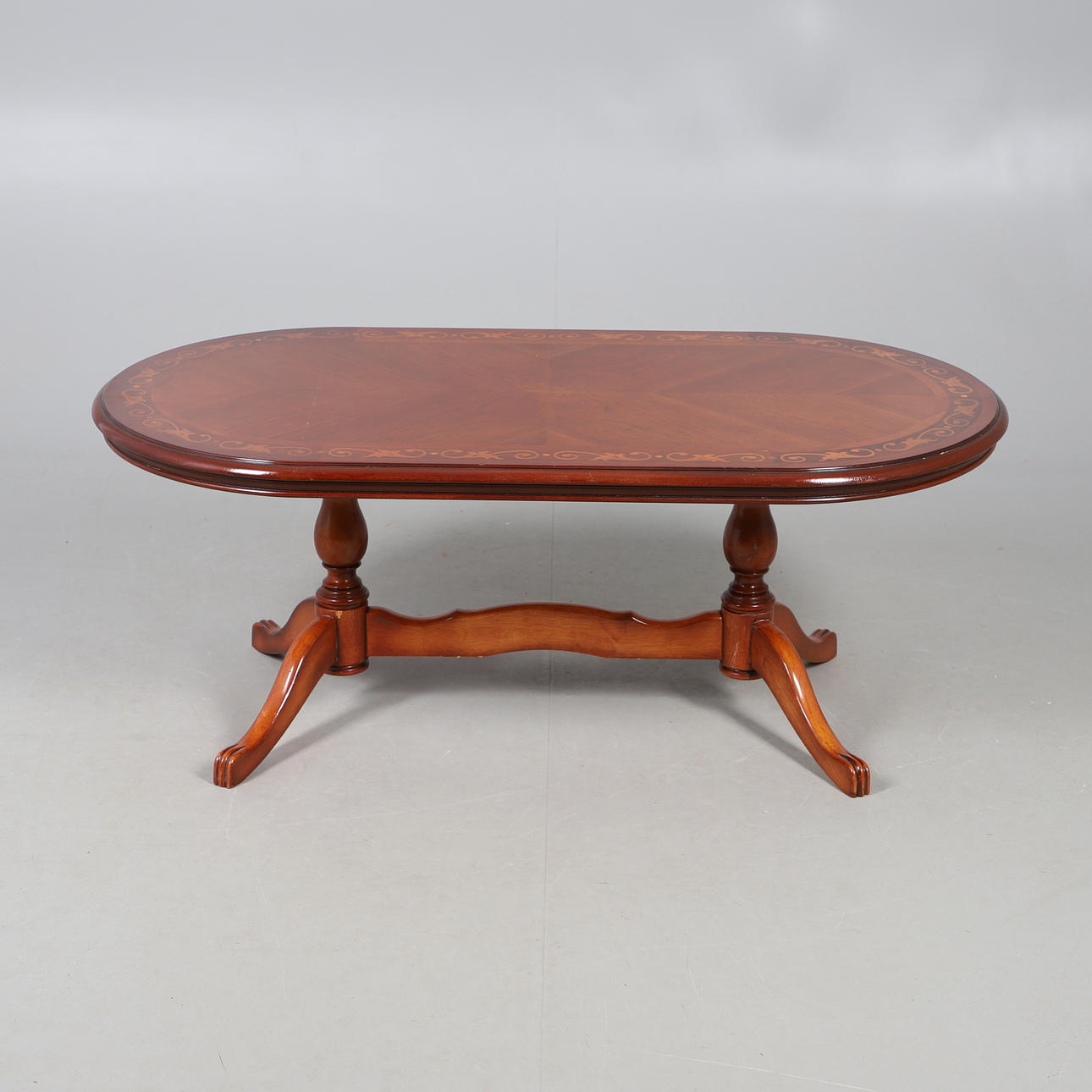 A REPRODUCTION COFFEE TABLE.