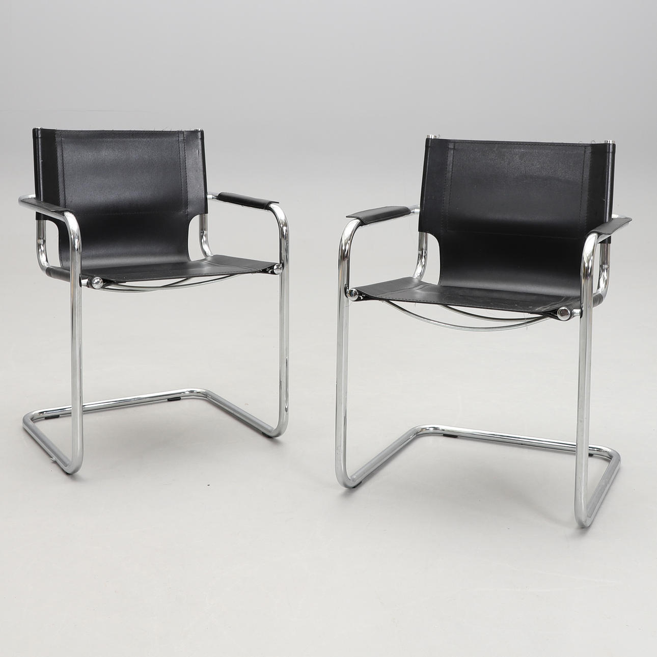 A pair of functional Italian armchairs.