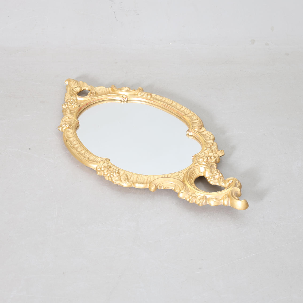 A ROCOCO STYLE MIRROR, A.B. Export list, Nyköping, 20th century.