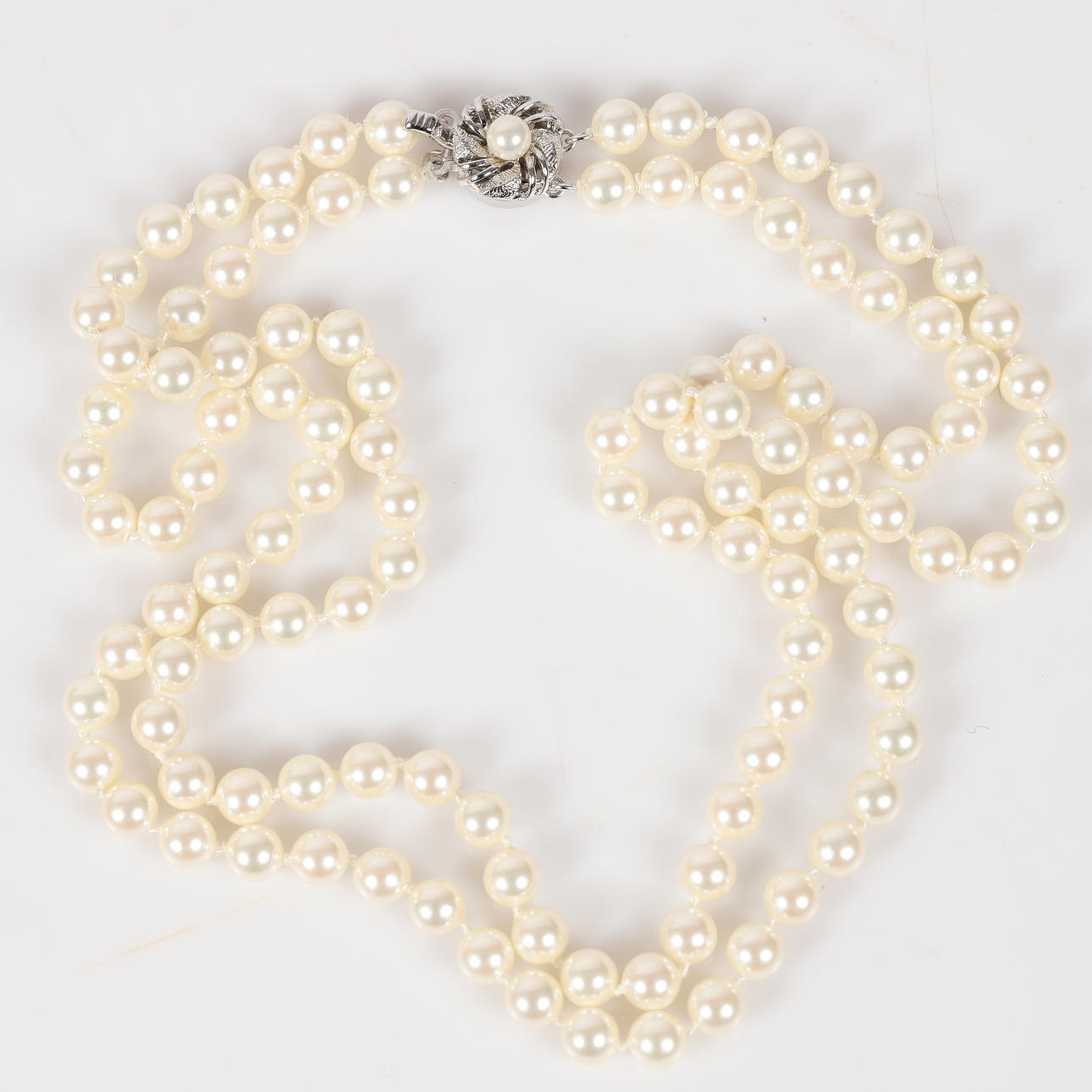 NECKLACE, 2-row, seashell pearls with silver clasp.