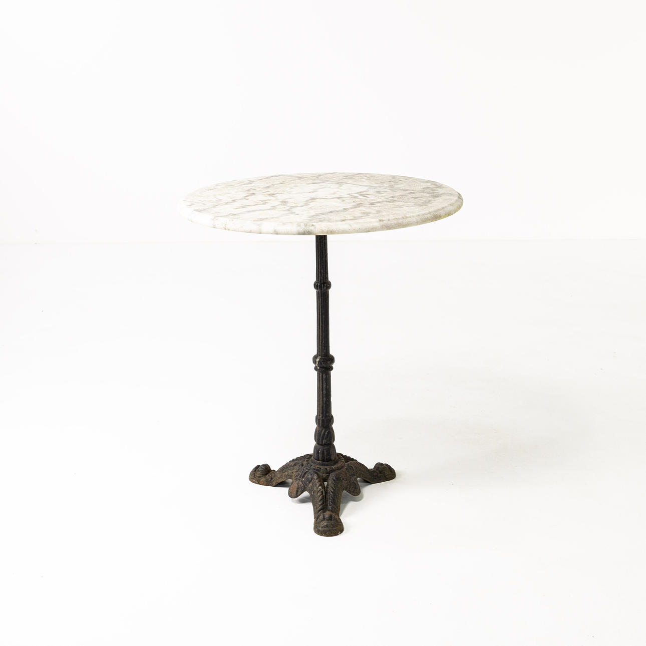 A late 20th century cast-iron/marble café table.