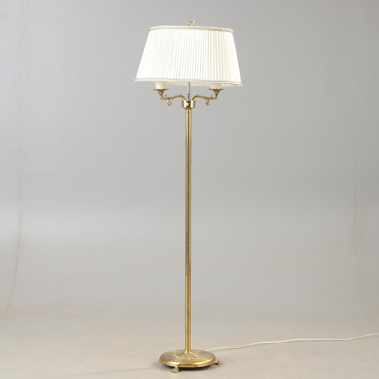 A brass floor lamp, mid 20th century.