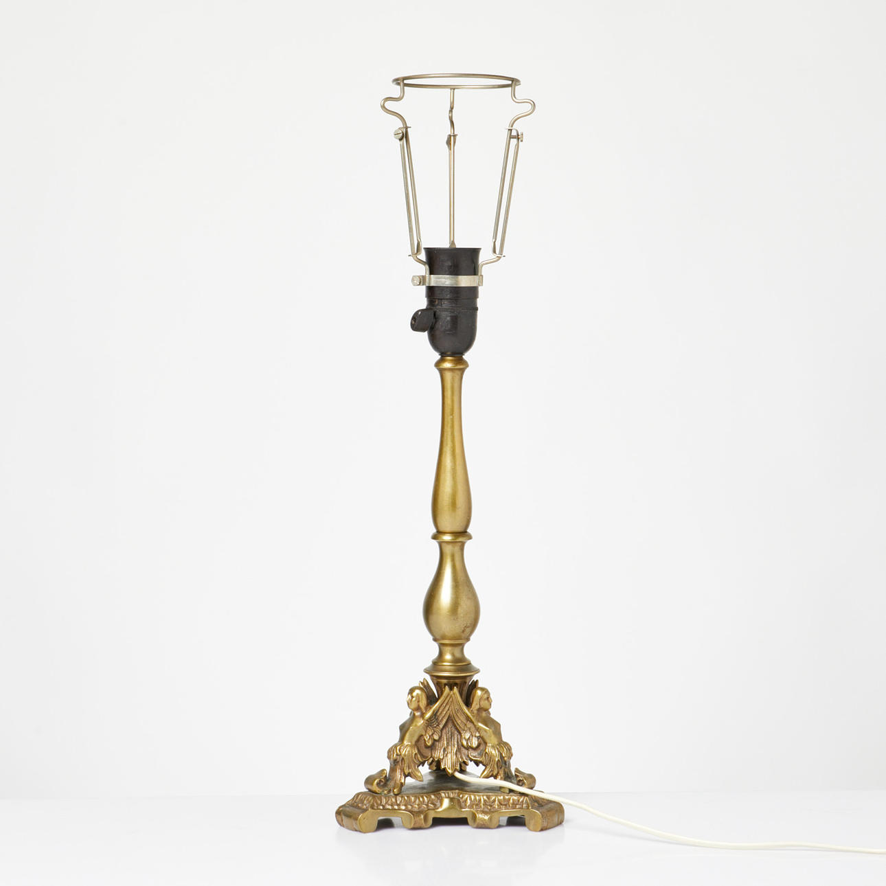 A brass table lamp, figural decor, 20th century.