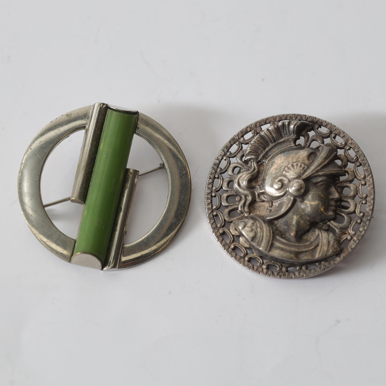 Two metal & bakelite brooches, 20th century.