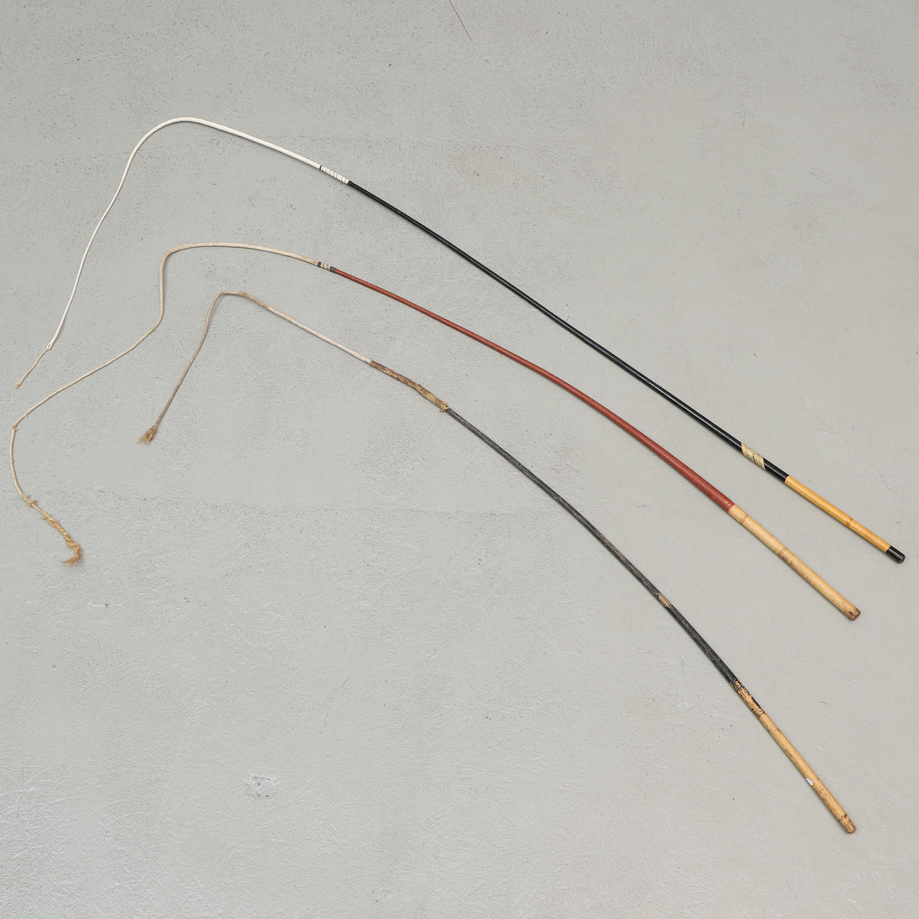 Three piping whips, 20th century.