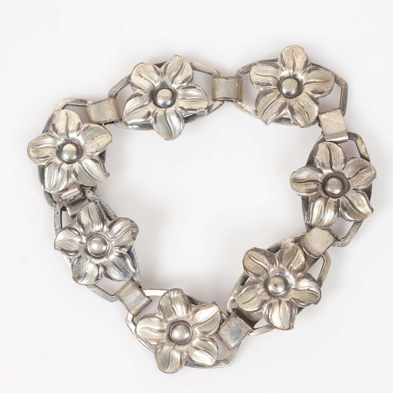 BRACELET, silver with openwork floral decor.